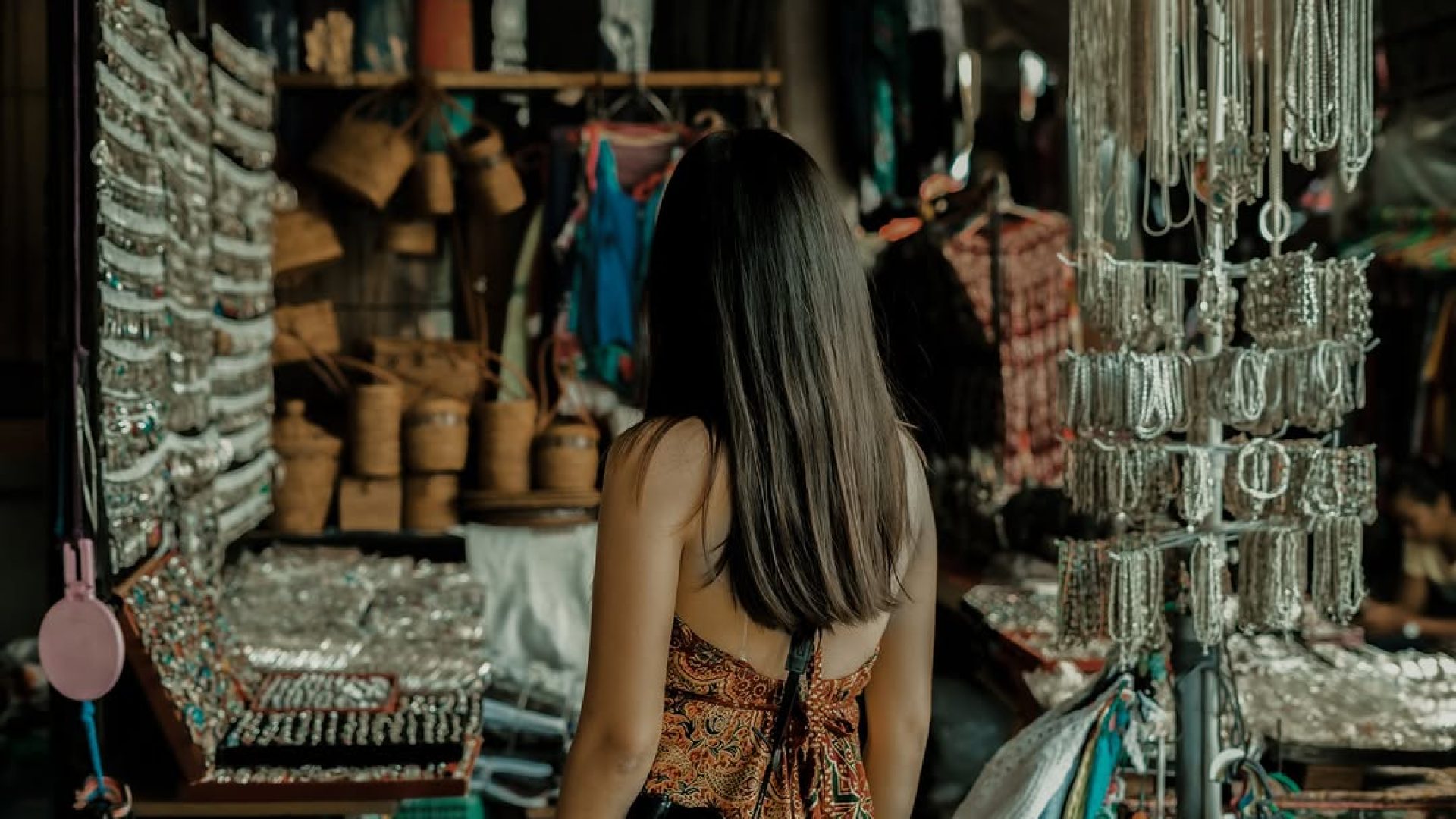 Young woman traveler looking for some souvenir at ubud market in bali